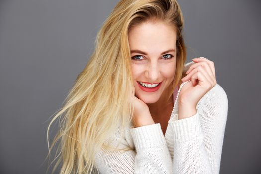 happy young blond woman with white cardigan