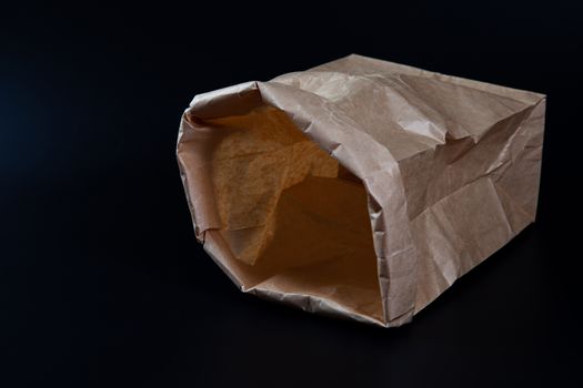 Paper bag mockup on black background. Wrinkle Brown paper bag ma