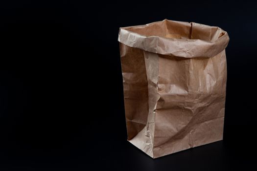 Paper bag mockup on black background. Wrinkle Brown paper bag ma