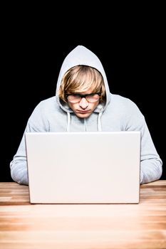  Man in hood jacket hacking a laptop