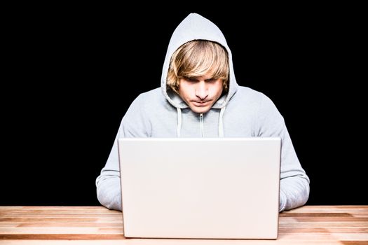  Man in hood jacket hacking a laptop