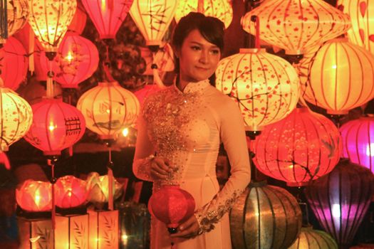 A Female Vietnamese tourist posing for a photo among the famous Vietnamese lanterns