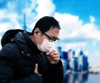 Asian  man suffer from cough with face mask protection