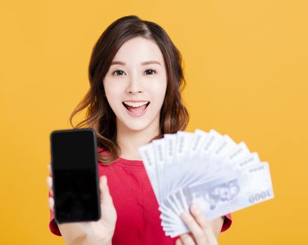 happy young woman holding mobile phone and money.