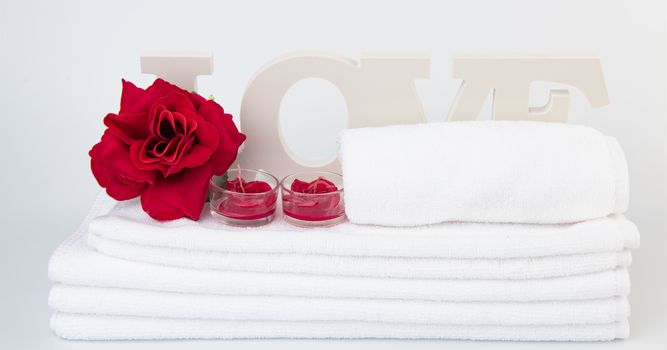 Spa wellness with red rose candles ,white towel and love text on