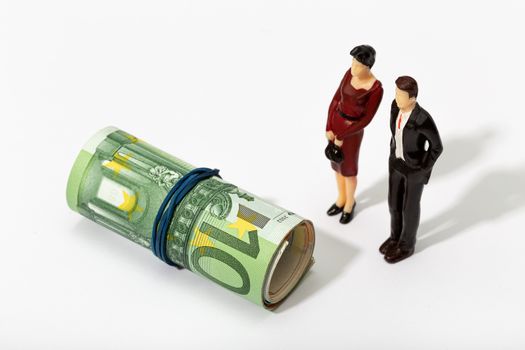 Human representation of a couple looking at a Roll of money