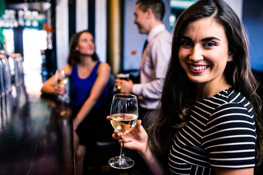 Portrait of woman having a drink with friends