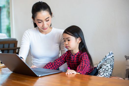 Asian mothers are teaching their daughters to read a book and us