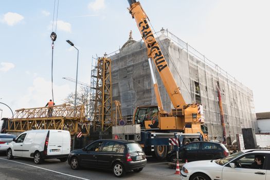 renovation site with a crane in operation and street atmosphere 