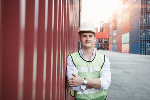 Portrait, Confident Transport Engineer Man in Safety Equipment Standing in Container Ship Yard. Transportation Engineering Management and Container Logistics Industry, Jobs Shipping Occupation