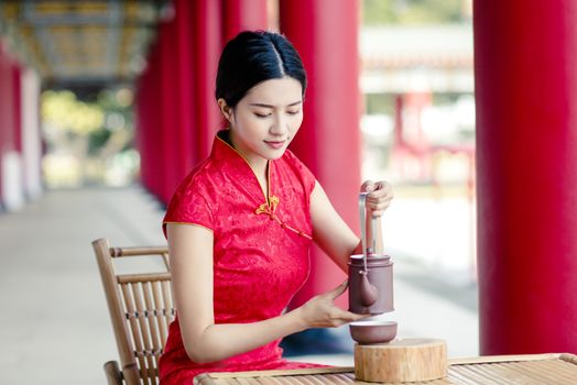 beautiful Asian  woman in old traditional Chinese dresses drinki