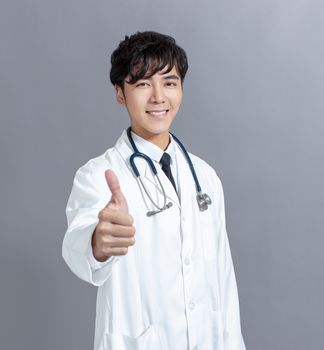 friendly asian doctor  giving thumbs up