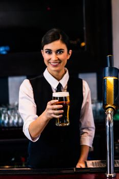 Barmaid serving a pint 