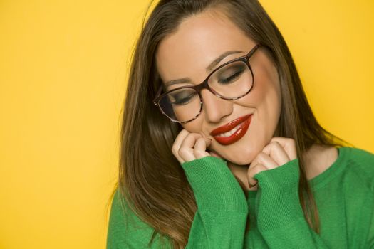 Portrait of beautiful happy woman with glasses and long hair