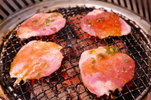 Pork grill on hot coals. This kind of food is a Korean or Japanese BBQ style.