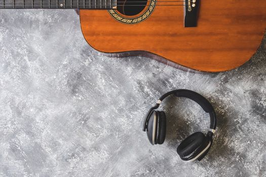 Top view of Guitar with headphone on grunge background