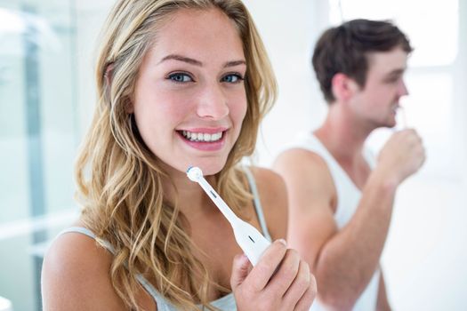 Young couple brushing their teeth at home 