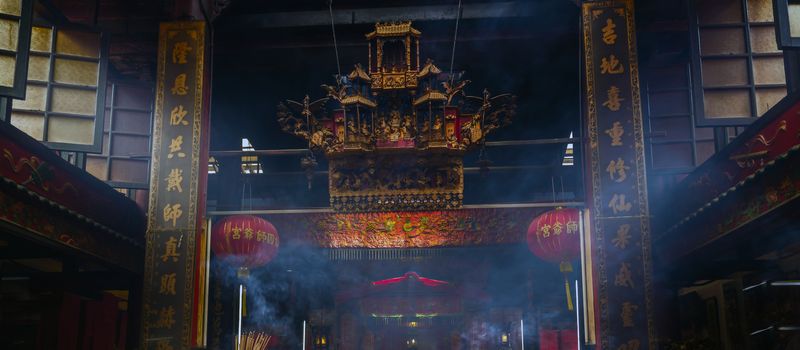 smoke of joss stick in old chinese temple