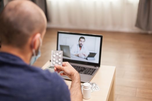 Adult man on video conference with doctor