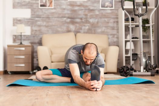 Athletic man stretching out before workout