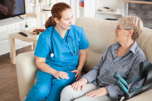 Health visitor with stethoscope on a couch in a nursing home