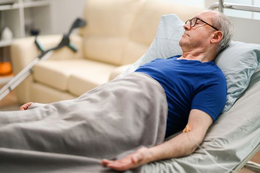 Senior man lying in nursing home