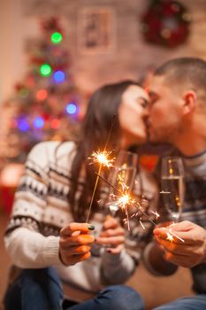 Hand fireworks flicker brightly holded by couple