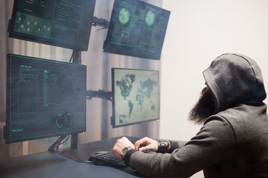 Side view of bearded hacker with a hoodie