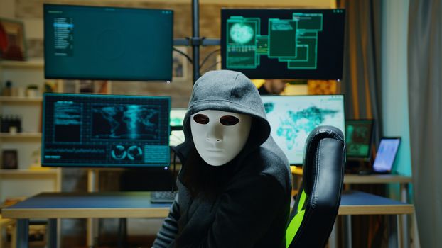 Masked hacker wearing a hoodie to hide his identity