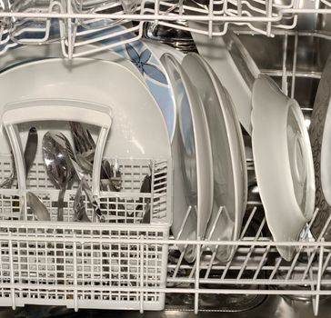 Dishwasher full of utensils, silverware