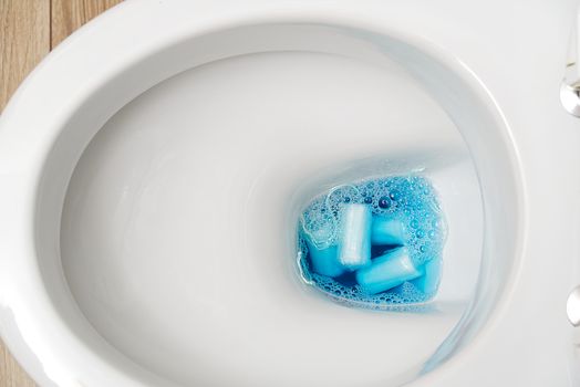 do not throw foreign objects, sanitary pads, tampons, paper, plastic into the toilet. Close-up of a toilet bowl clogged