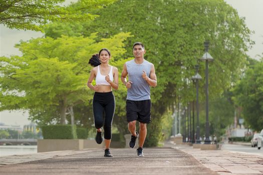 Couples who take care of their health by exercising happily in t