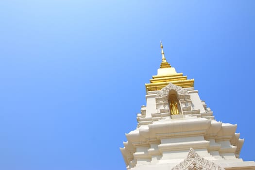 Religious architecture and beliefs, a beautiful white Thai temple on a blue sky