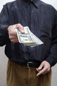 Businessman, or politician, offering a Dollar banknotes bribe fo