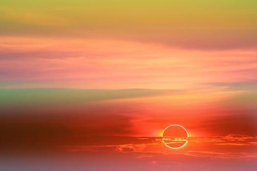 annular eclipse over colorful soft cloud sunset sky