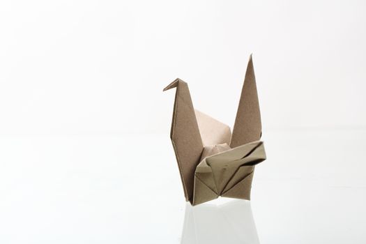 Origami bird papercraft by recycle paper isolated in white backg