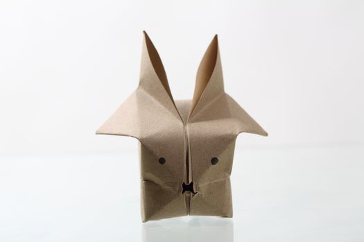 Origam rabbit papercraft by recycle paper isolated in white back