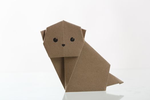 Origami dog papercraft by recycle paper isolated in white backgr