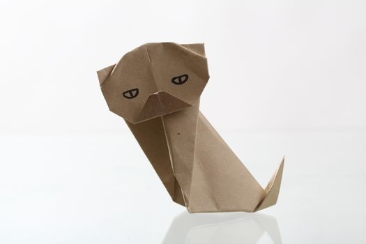 Origami dog papercraft by recycle paper isolated in white backgr