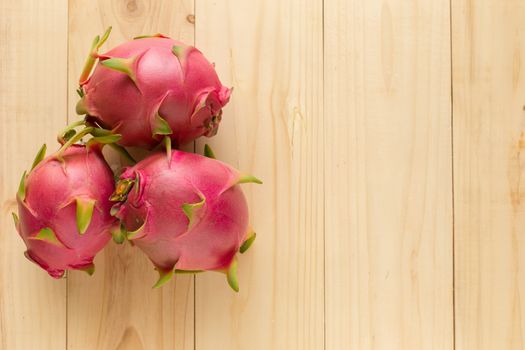 Tropical dragon fruit on wooden background. Top view