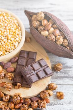 Corn kernels in wooden plates and popcorn with Caramel and choco