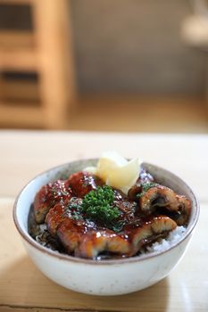 Japanese food unagi don , grilled eel on japanese rice on wood b