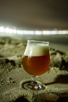 A glass of beer at Copacabana Beach in Rio De Janeiro, Brazil. Night lighting