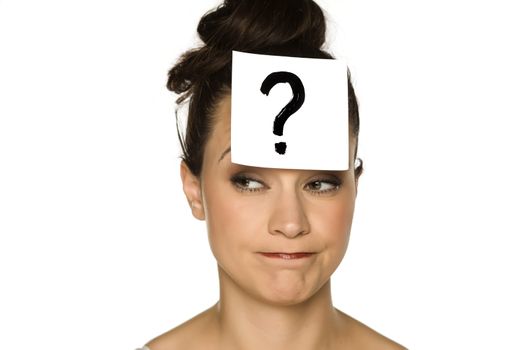 a young confused woman with a drawn question mark on paper