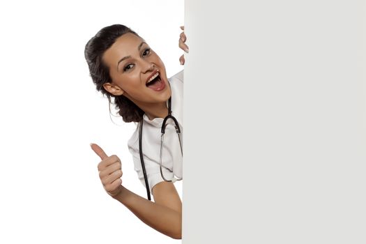 woman doctor peek behind the white blank board