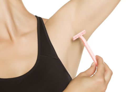 Woman shaving her armpit