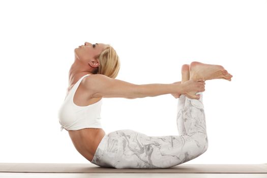 woman in white sportswear doing yoga practice