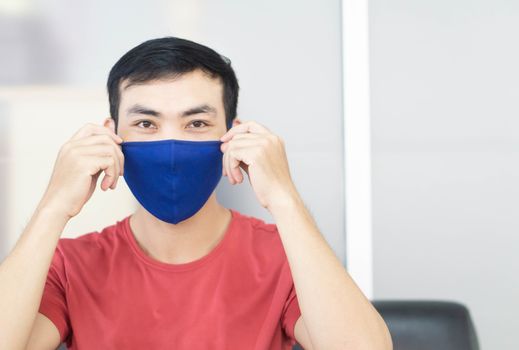 Closeup asian man wearing face mask for protect air polution or 