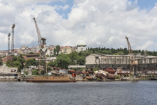 Derelict dockyard by river in city