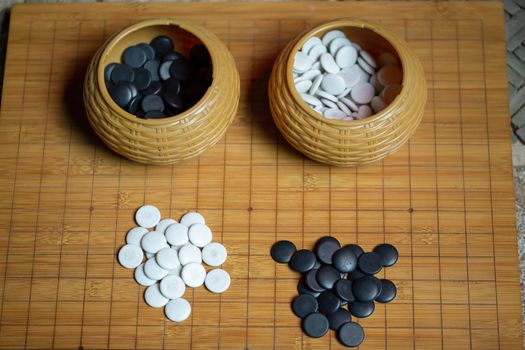 Go board game playing. A competitor is placing a marble piece on